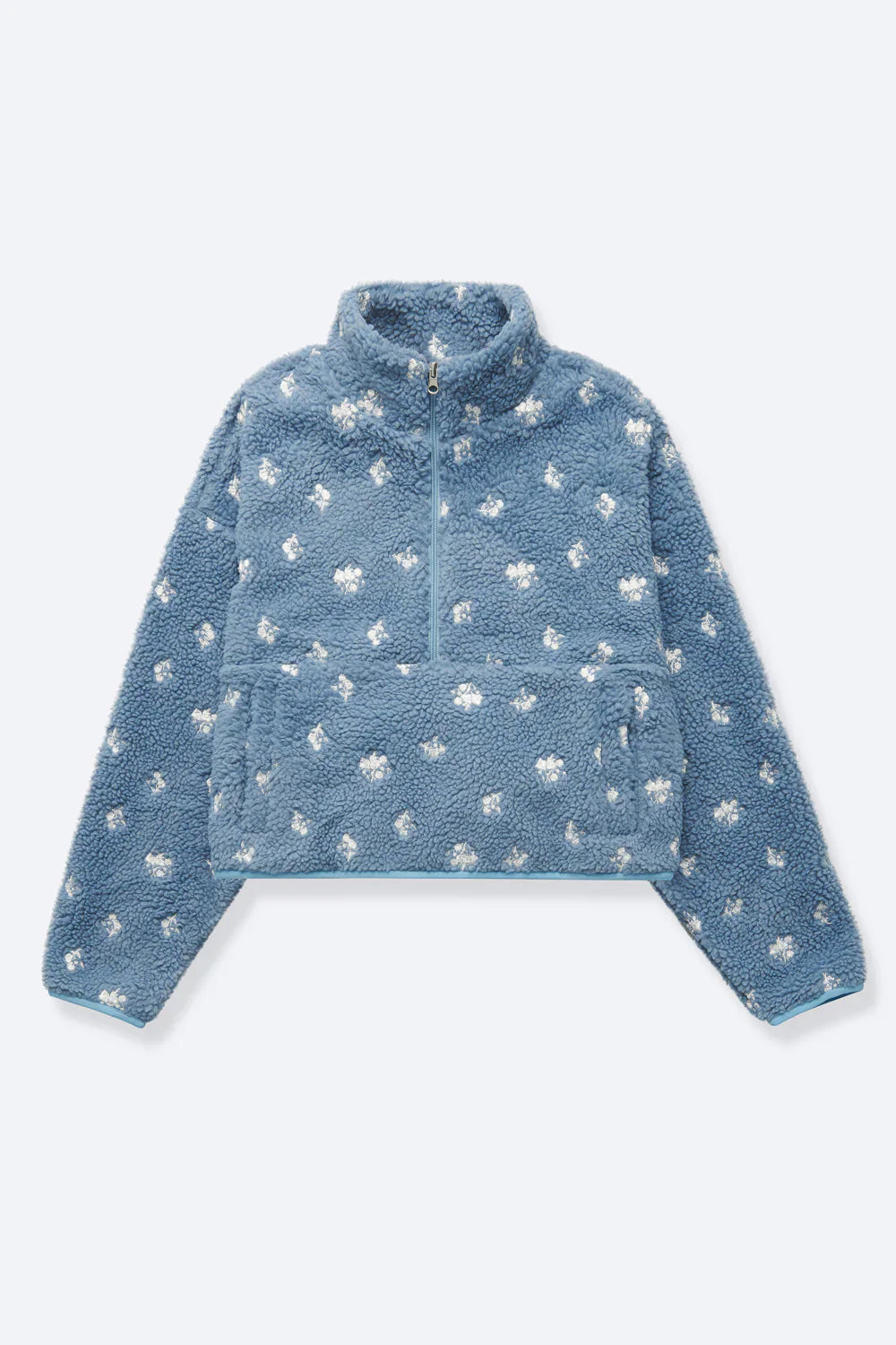 Blue fleece pullover with white patterns on a light gray background